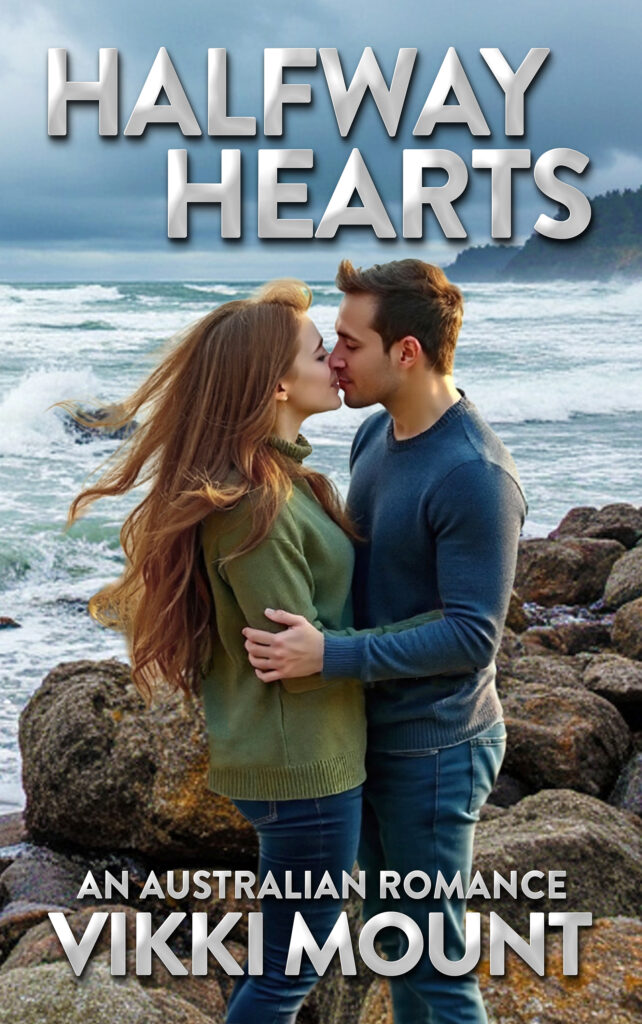Woman with long hair kissing man while standing on rocky landscape with sea in the background